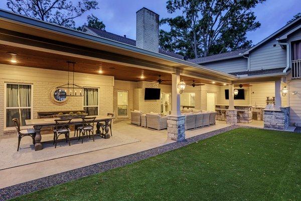 Large outdoor living space with a custom outdoor kitchen