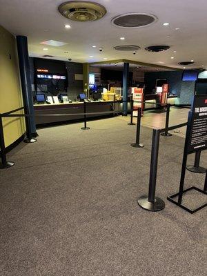 Carpet tile installation in the entrance and waiting area of a moving theater