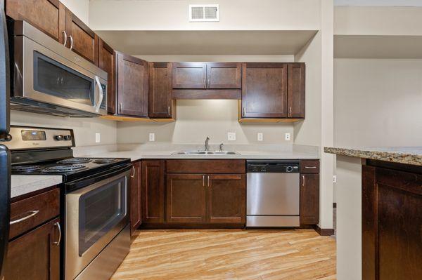 Full kitchen with upgraded cabinets and stainless steel appliances.