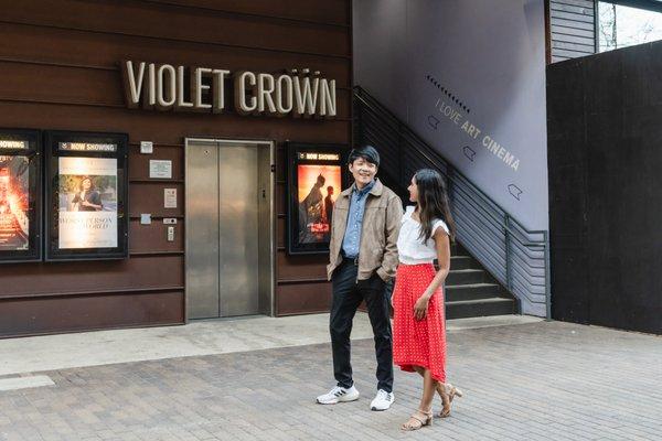 A couple walks past 2nd Street District tenant Violet Crown