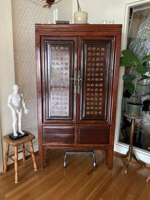 Chinese medicine storage cabinet with poem for rest and sleep.