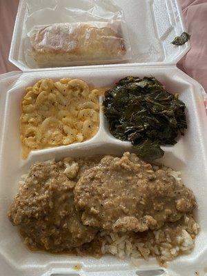 Smothered pork chops with rice and gravy , Mac and cheese, collards, cornbread