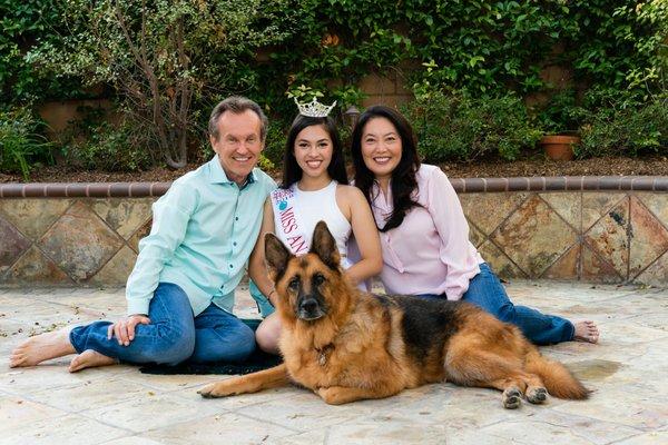 Dr. C. and Dr. Kim with their daughter, Ele and dog, Tinsel