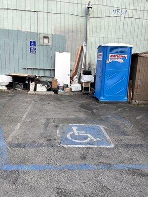 Portapotty in the parking lot where the older server told my husband to go and use.