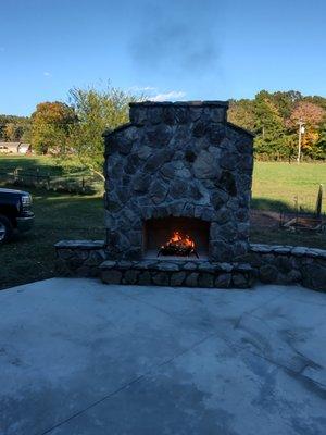 Outdoor Stone fireplace with sitting wall