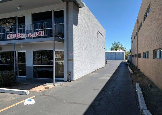 Small driveway from 16th St. that goes behind the strip center to Field Services. July 2018.