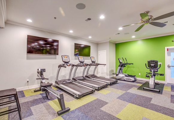 gym with state-of-the-art machines and flat screen TVs