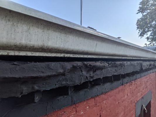 BEFORE: huge gap between the gutter and the wall (the gutter also wasn't sloped properly), which is where tons of rain got into our house.