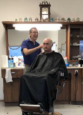 Barber and customer in the chair.