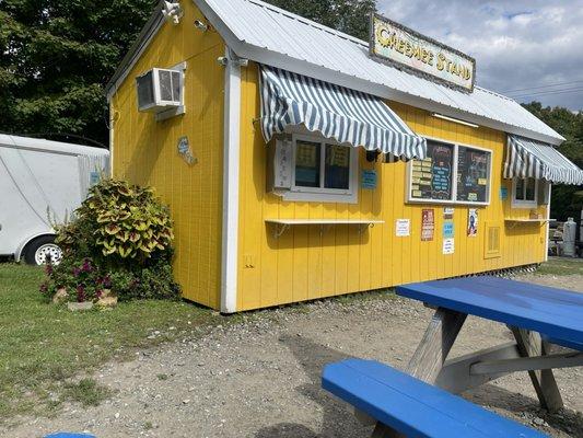 The yellow Creemee Stand and blue picnic table