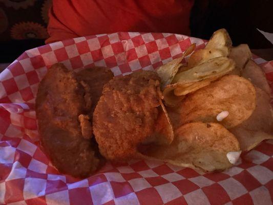 Chicken tenders tossed in hot sauce with home chips