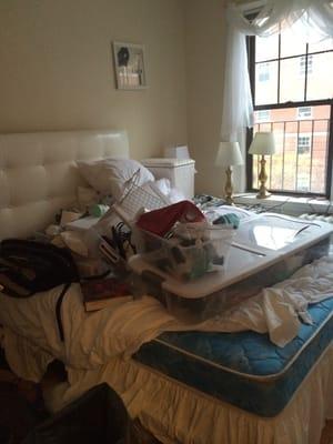 A picture of my bed after Inbound used it as a dumping ground when making repairs in my apartment.