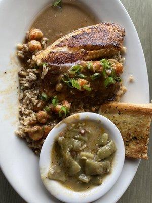 Blackened Fish topped with Cajun Étoufée, green beans, and garlic bread