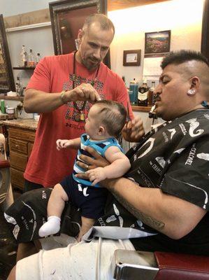 Anthony giving my 3 month old son his first haircut.