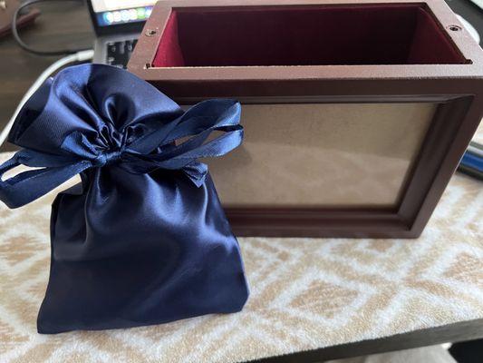 The ashes are inside a plastic sealed bag inside of this blue bag which was obviously inside the wooden urn box