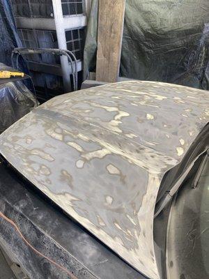 Chevy Camaro Hood getting sanded to bare metal because of fading