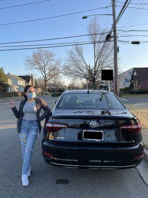 A happy customer with her brand new 2021 Jetta SE!