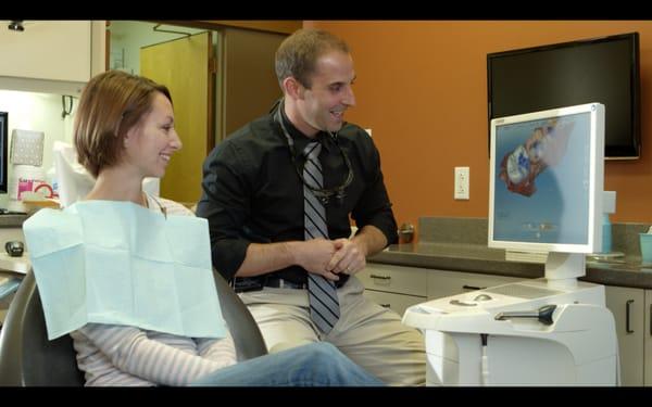 Dr. Chlebicki explaining to a patient how her new crown will look.