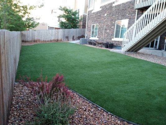 Custom shaped backyard artificial turf.