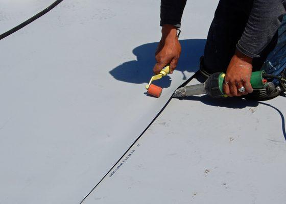 TPO getting its first of two welds to bond two sheets making them one.