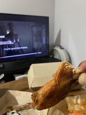 This is a chicken wing with the entire feather on it.