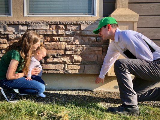 Our pest technician explaining our service to our customer.