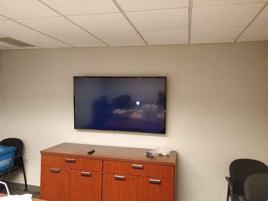 Tv mounted in the office meeting room.