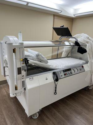 This is what the Hyperbaric Oxygen Therapy Chamber looks like at the Center. Notice the Monitor above as you Watch Movies in the Chamber too