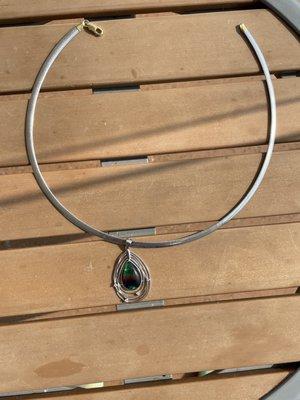 Photo of pendant and omega taken outdoors