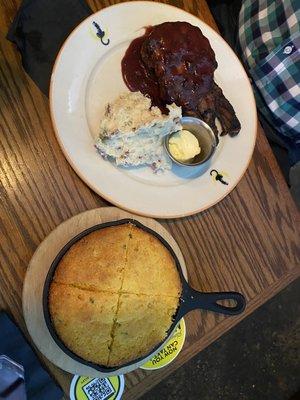 Cherry glazed pork chop, mashed potatoes and corn bread