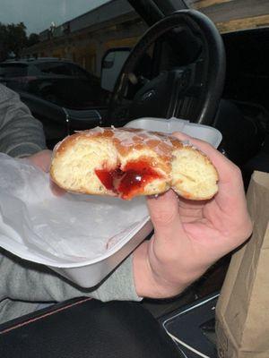 Glazed raspberry filled donut