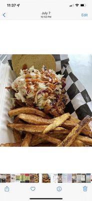 Pulled pork sandwich with coleslaw and fresh cut fries