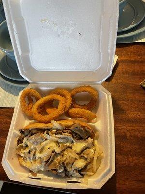 Philly Cheesesteak (1/4 lb Meat. Topped with Swiss Cheese, grilled onions and mayonnaise.) & onions rings