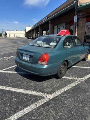 Pizza Hut employee parked between handicap parking spaces