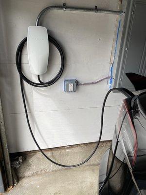 Tesla Wall Connector installed near panel