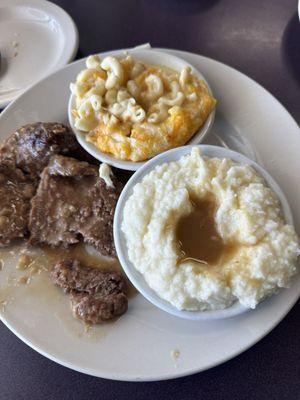 Country steak with mashed potatoes and Mac & cheese.