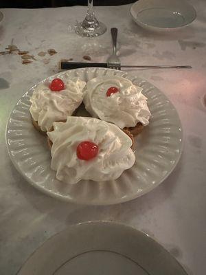 Part of the dessert. Pumpkin rolls with whipped cream and a cherry on top.