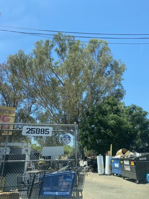 Outside parking lot, walk in through gates to recycle