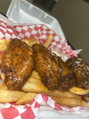 Smoked wings with buffalo sauce and seasoned fries