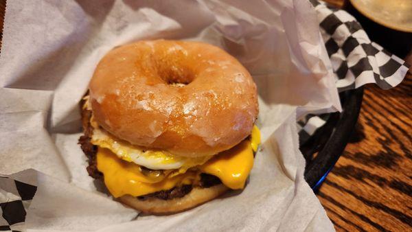 Showalter burger. Applewood bacon, cheese, and a whole egg. On a halved doughnut.