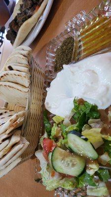 Labneh Smooth, creamy dip made of goat milk with delicious lemony taste, topped with olive oil,zhatar served with hot pita bread