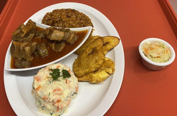 Oxtail (complet) with rice/beans fried plantains or fries including in house salad potatoes