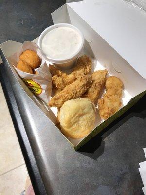 Combo #1.  4 chicken strips, biscuit cream gravy and a side of corn nuggets.