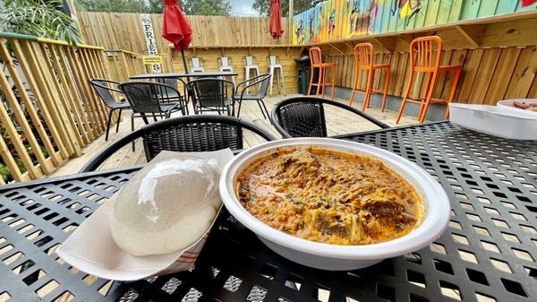 Egusi with Goat Meat and Fufu at their back patio