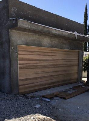 New stained grade sectional cedar wood garage door