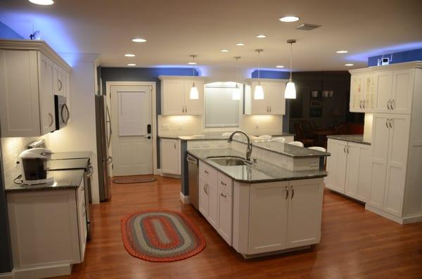 shaker white kitchen with granite countertops and multicolored LED lighting