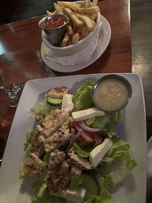 Greek salad with chicken and fries