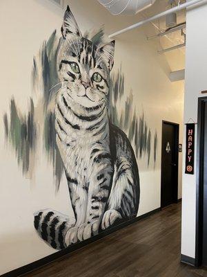 Inside: huge kitty painted on the wall beside the bathroom