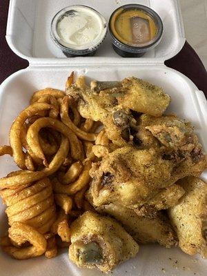 Lemon pepper wings and curly fries with ranch and garlic parmesan sauce