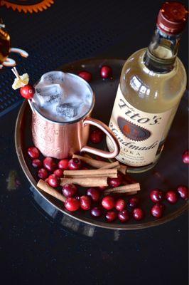 Tito's spiced cranberry mule, cocktail, bar area